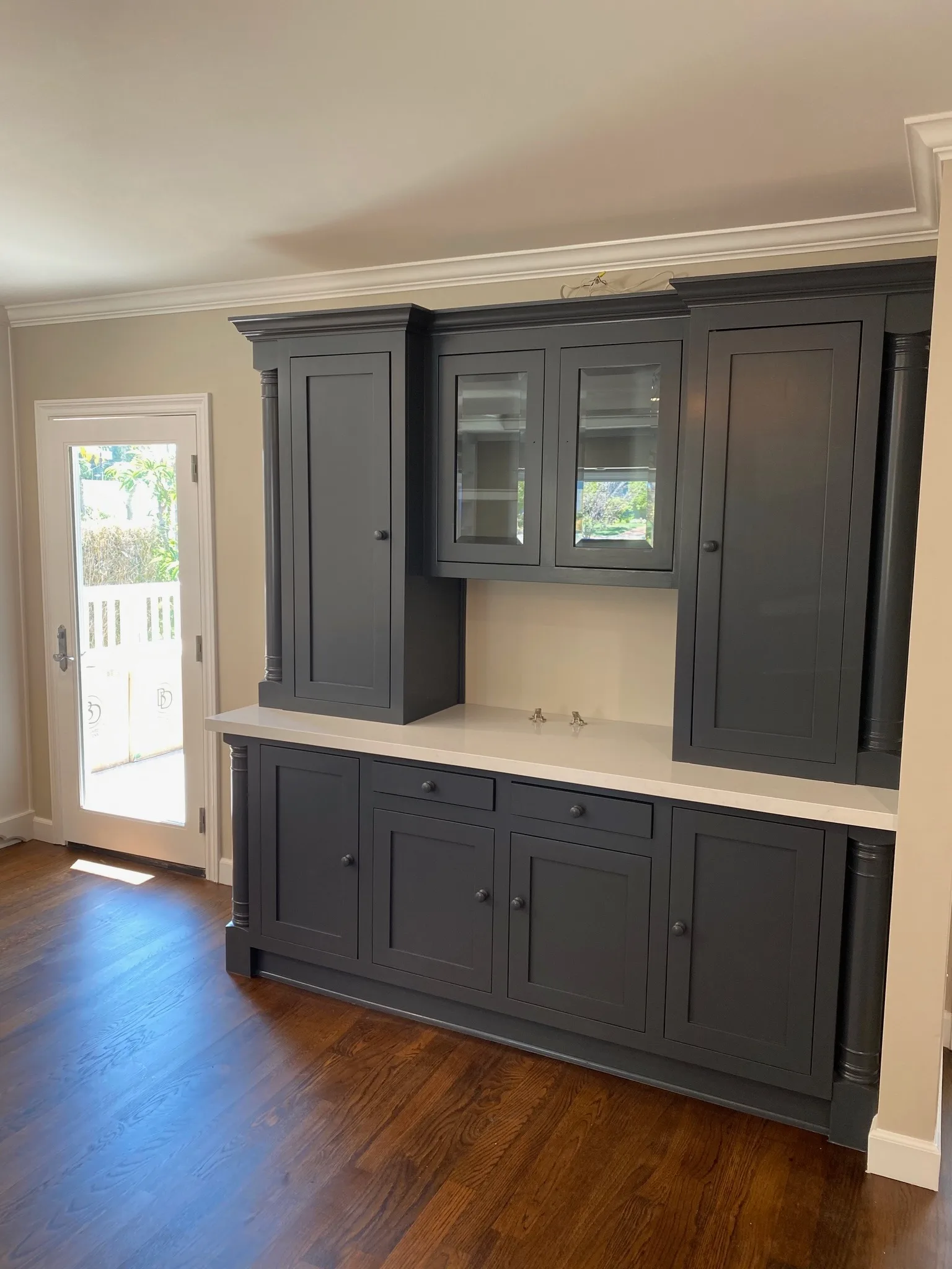 Built-in hutch refinished in deep navy with glass uppers