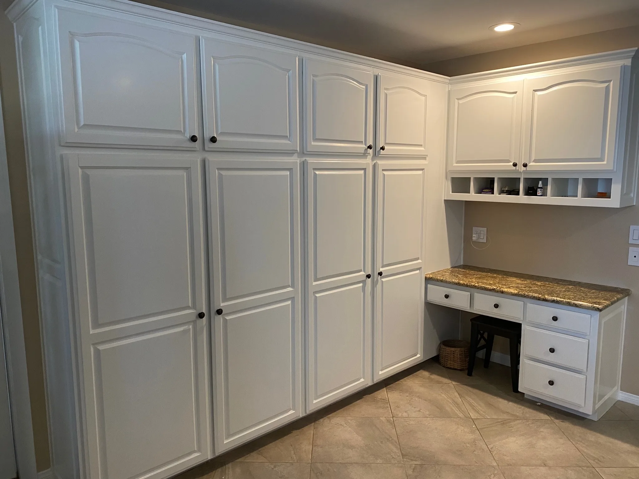 White built-in media console beneath a wall-mounted TV