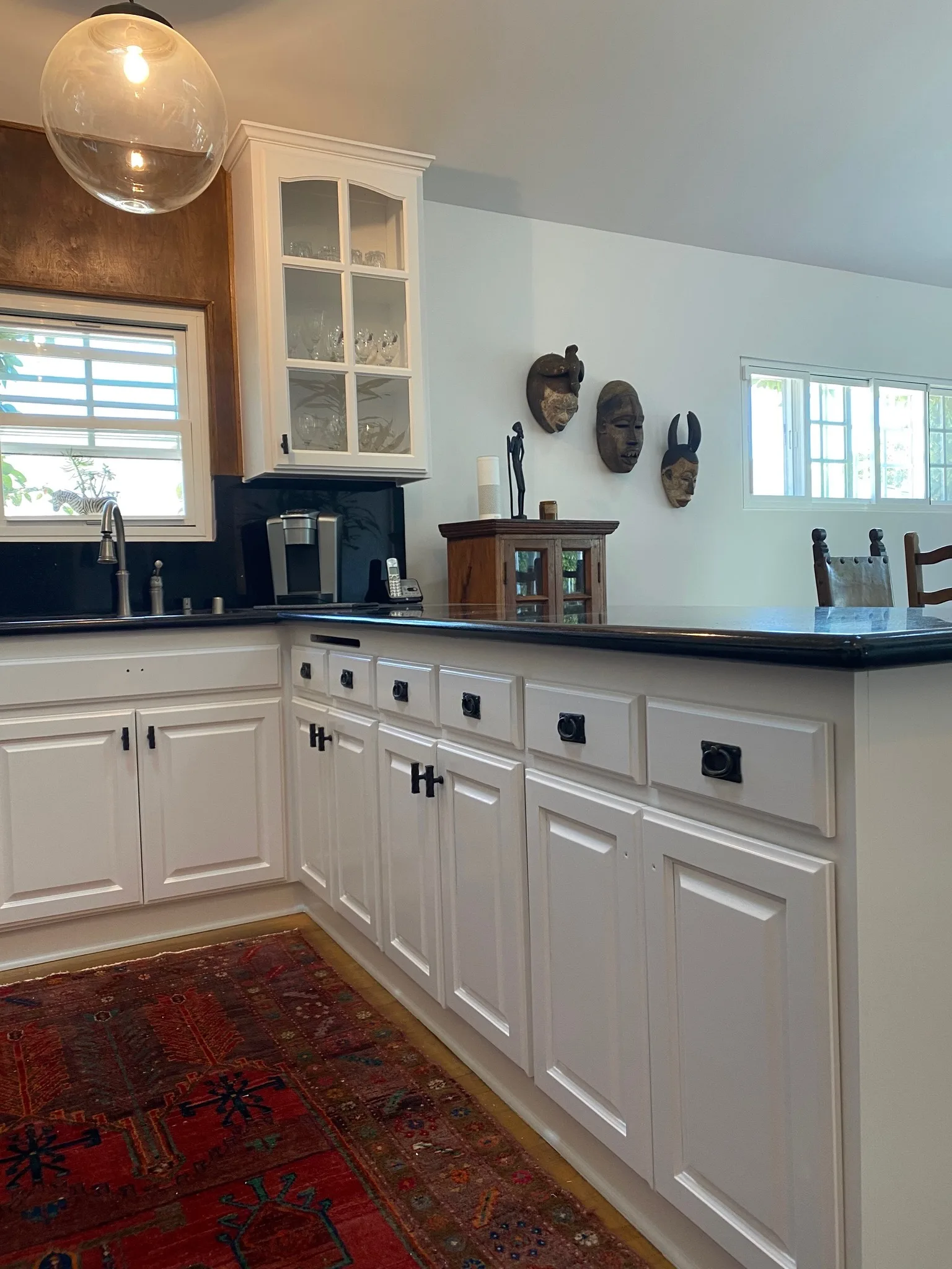 White refinished cabinets with black countertops
