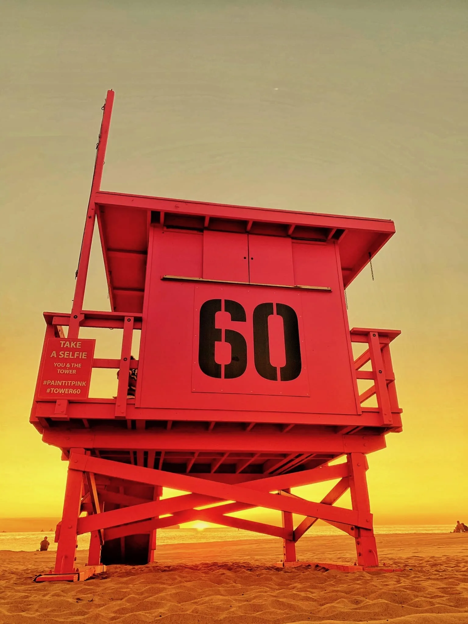 Lifeguard tower 60 repainted in red-orange at sunset