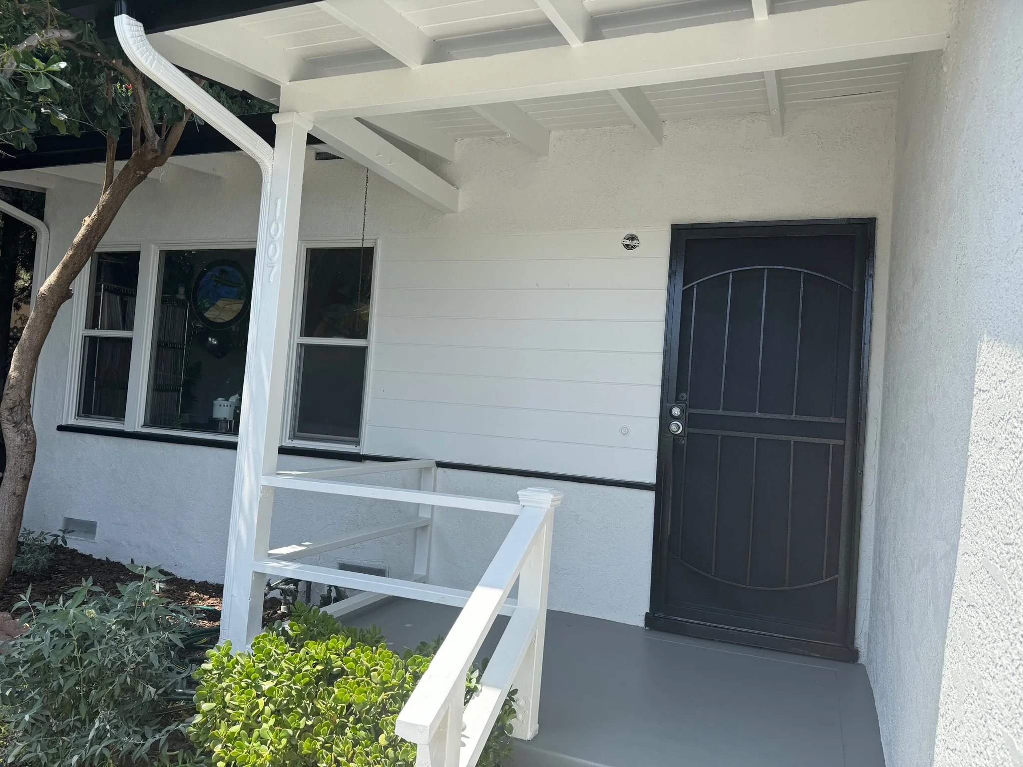 White porch with freshly coated gray floor