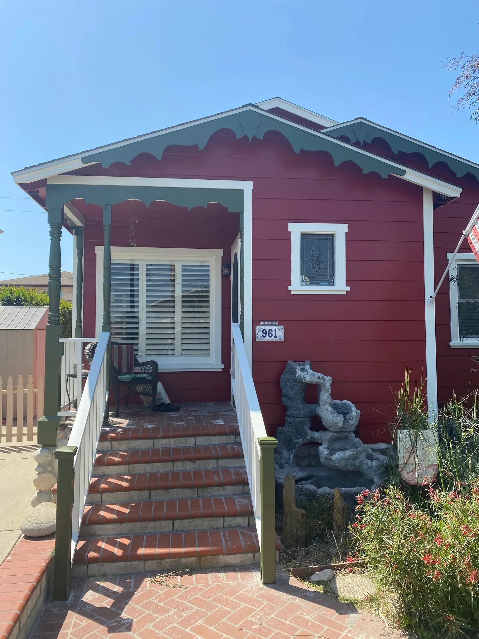 Red cottage exterior with fresh trim paint and front porch