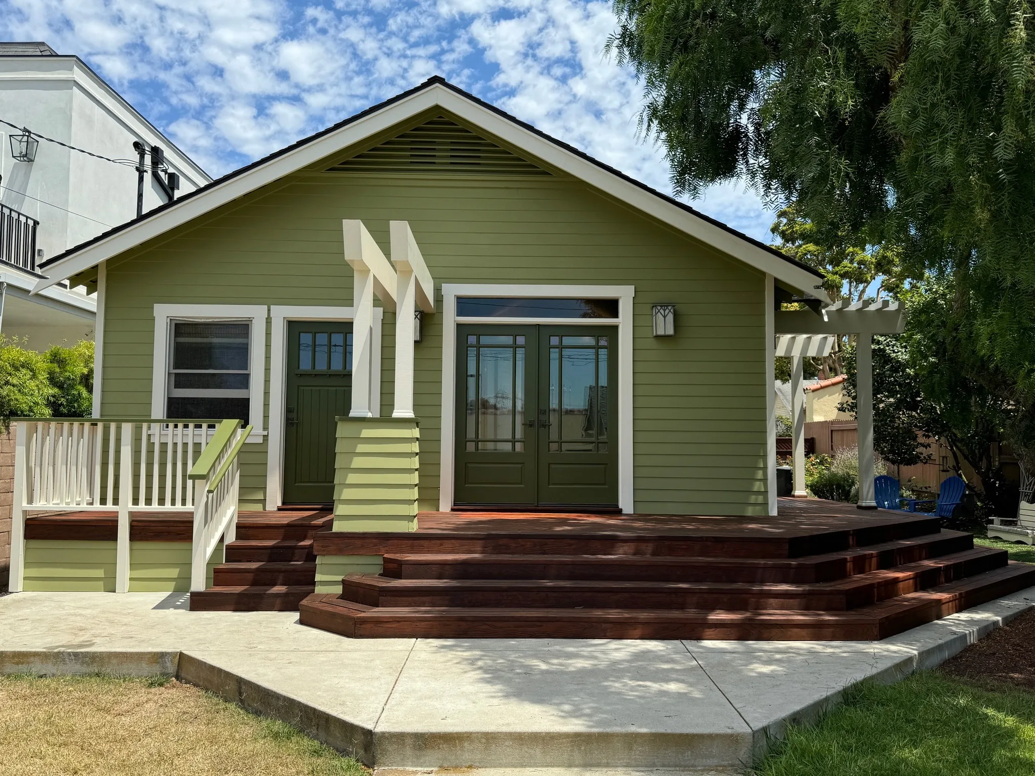 Olive green craftsman home with crisp white trim