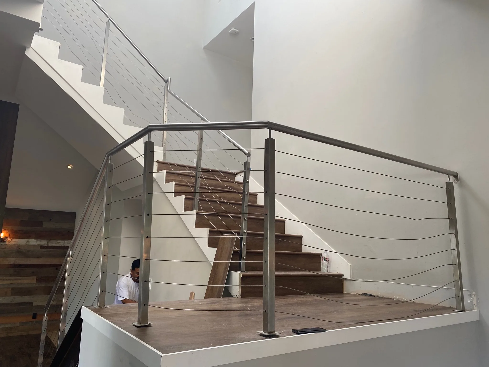Modern interior staircase with painted white walls and wood treads