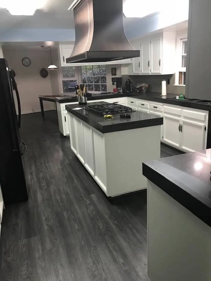 Kitchen with refinished white cabinets and dark countertops