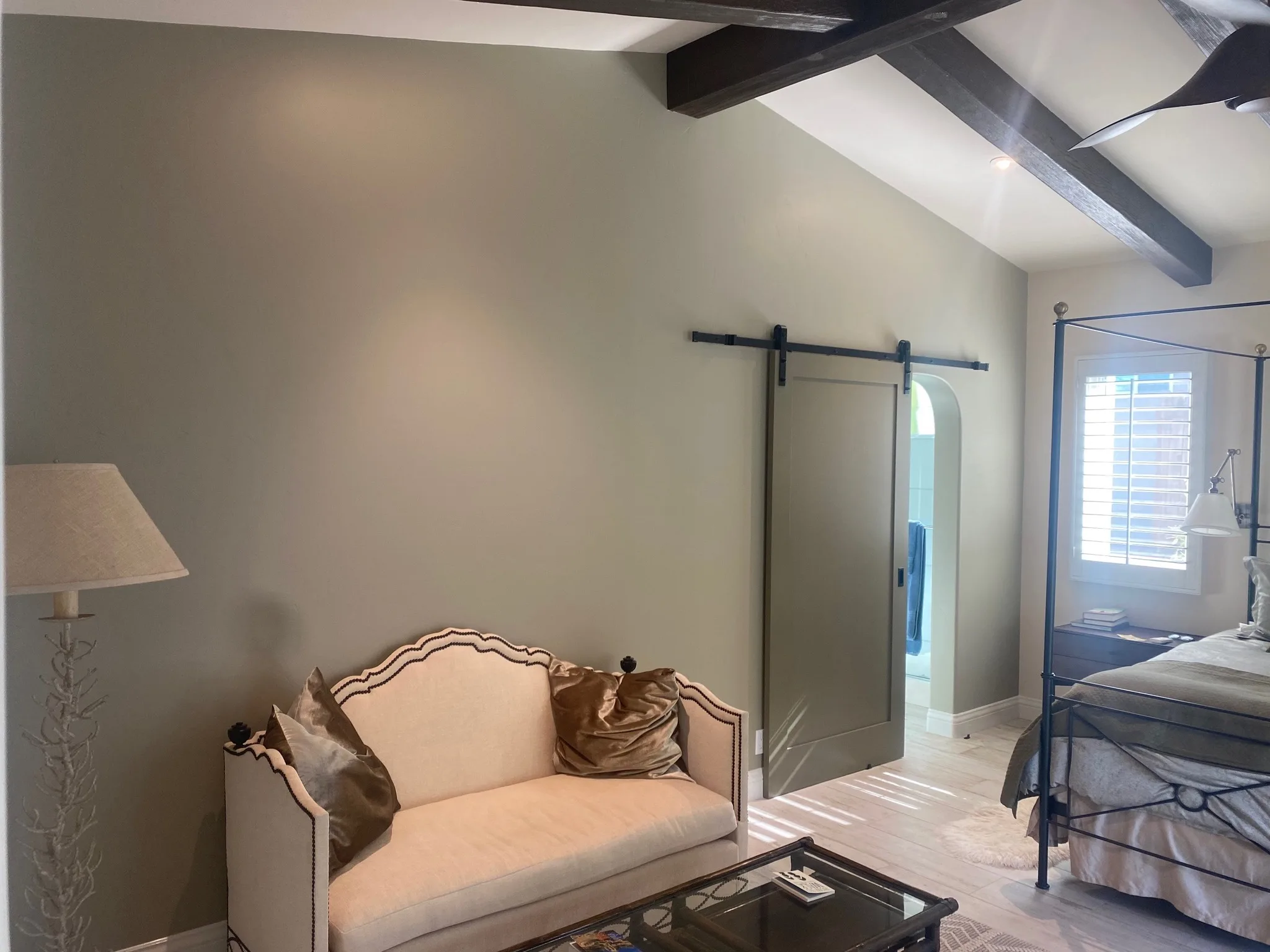 Sitting room with painted walls, barn door, and elegant furniture