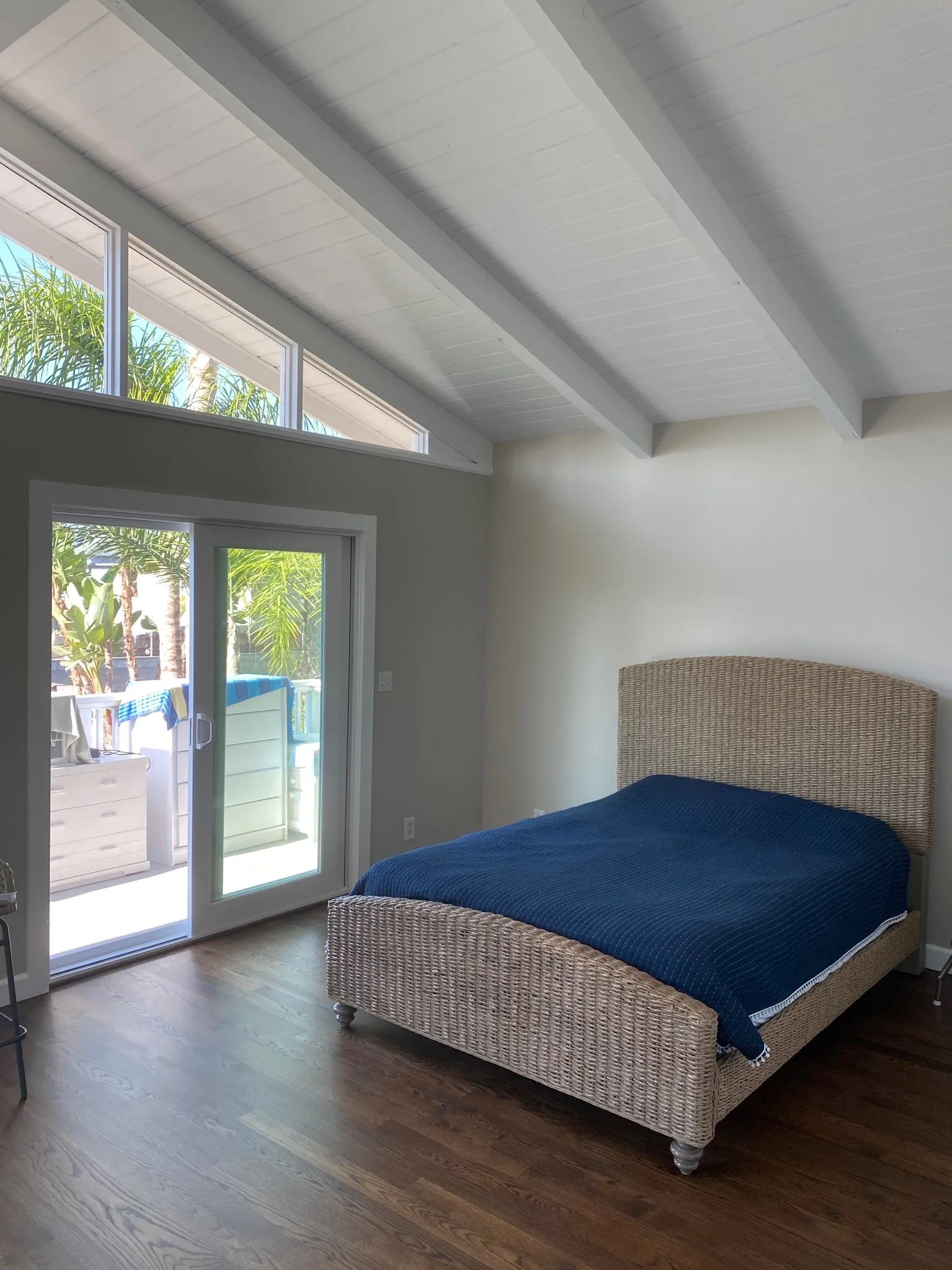 Bright bedroom with freshly painted white walls and vaulted ceiling